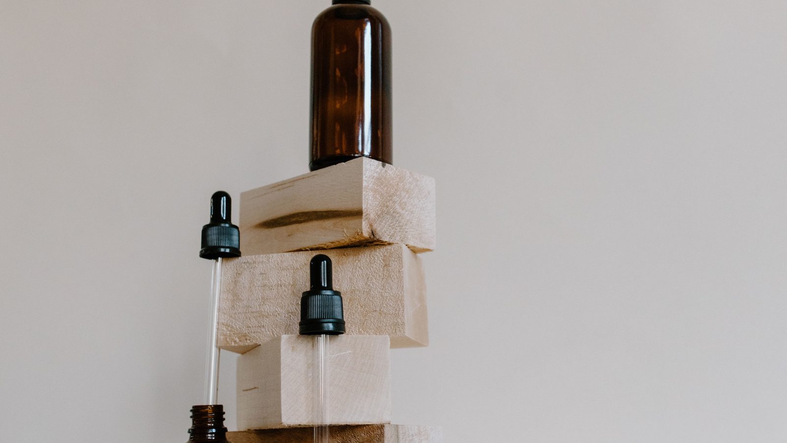 Essential oil bottles and building blcoks to show why aromatherapy is central to skincare formulation