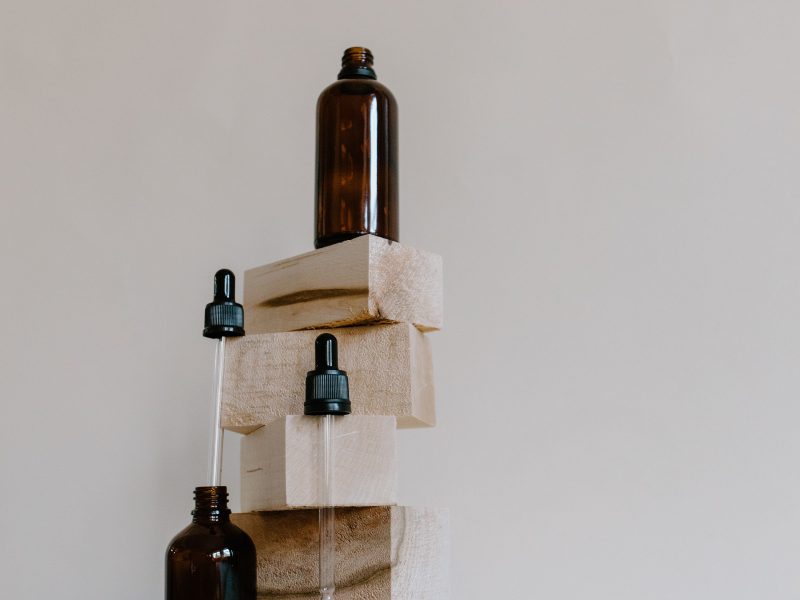 Essential oil bottles and building blcoks to show why aromatherapy is central to skincare formulation